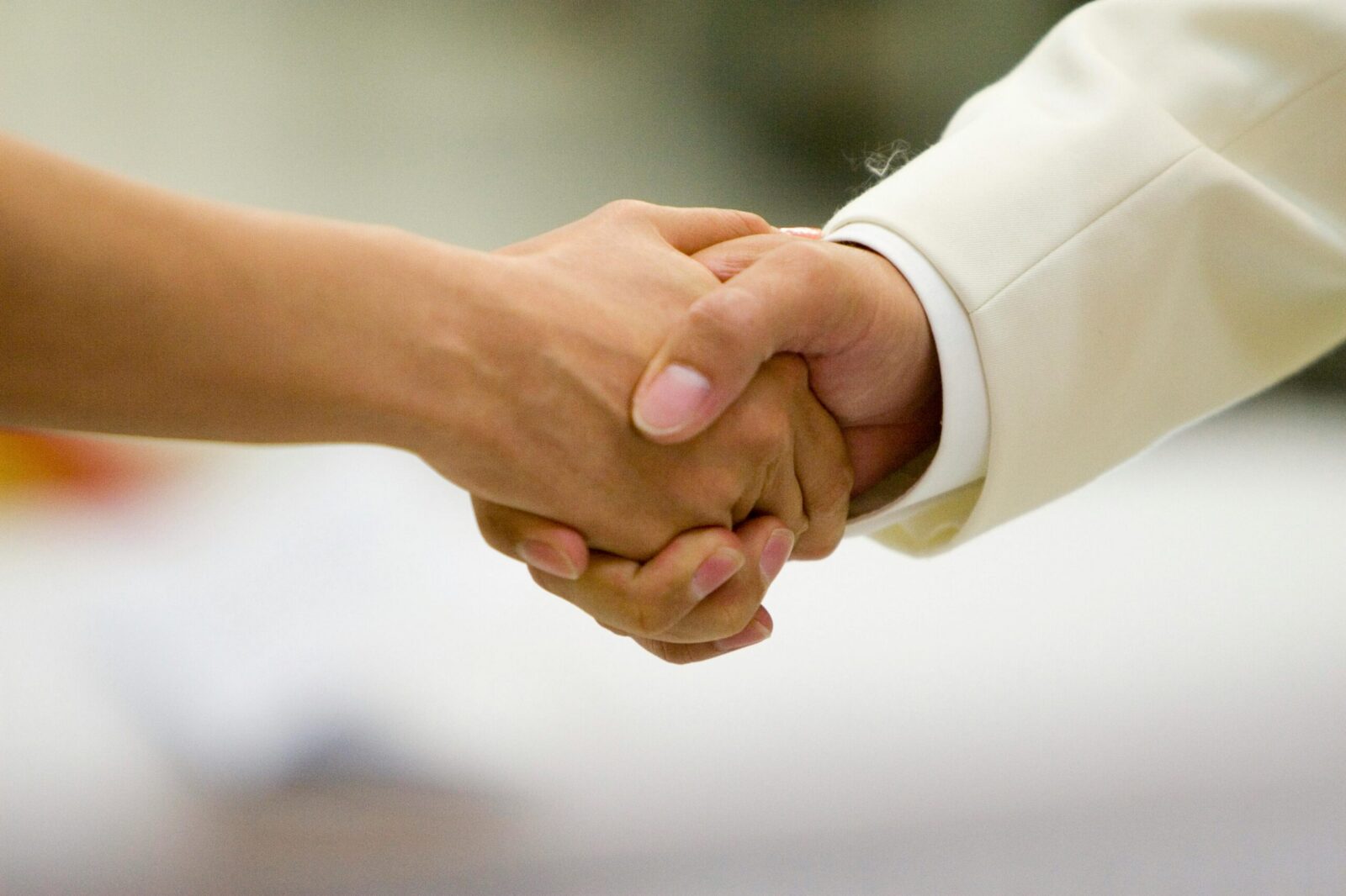 An intimate moment capturing a couple holding hands, symbolizing love and unity during a wedding ceremony.