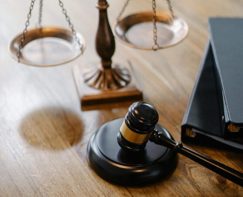 High angle lawyers desk with decorative judgement scales and gavel in modern law firm