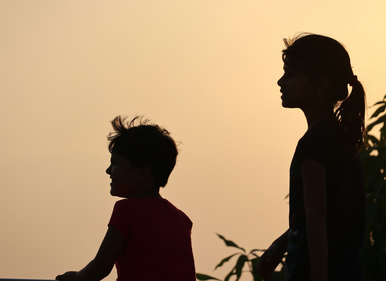 a couple of kids standing next to each other